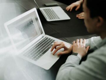 a man sitting in front of a laptop computer