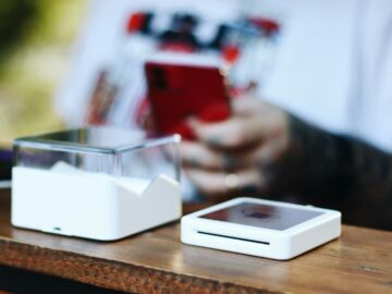 a person sitting at a table with a cell phone