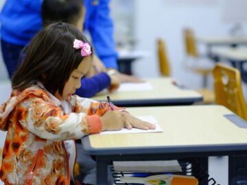 toddler sitting on desk
