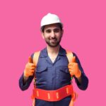 a person wearing a hard hat and holding a yellow tool