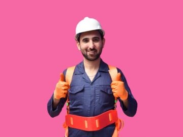 a person wearing a hard hat and holding a yellow tool