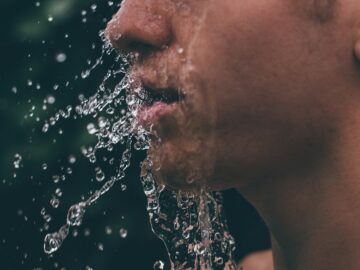 man face with water droplets