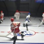 Miniature hockey players play a game on the rink.