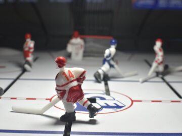 Miniature hockey players play a game on the rink.