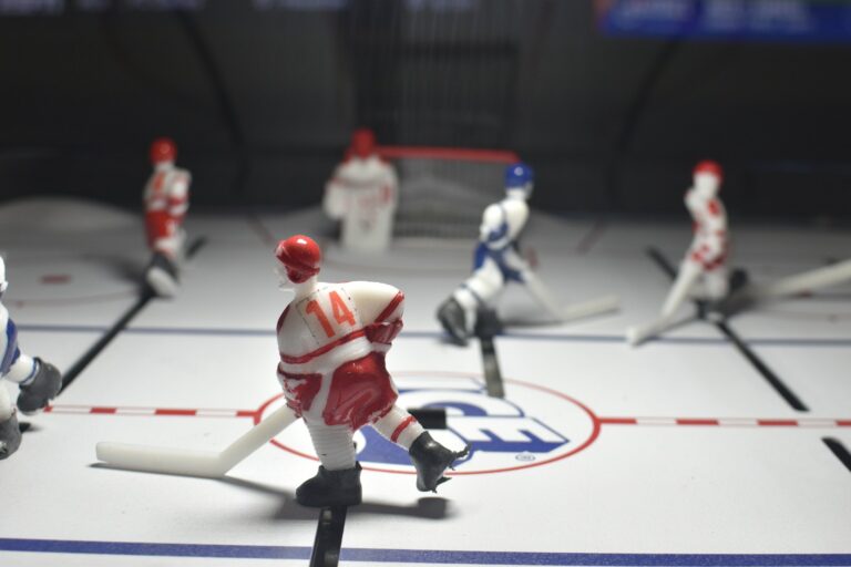 Miniature hockey players play a game on the rink.