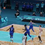 Basketball players compete on a court during a game.