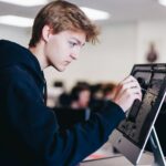 a young man working on a laptop computer