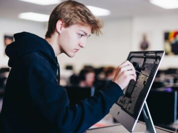 a young man working on a laptop computer