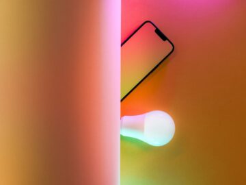 a cell phone sitting on top of a table next to a light