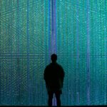 a person standing in front of a wall of lights