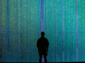 a person standing in front of a wall of lights