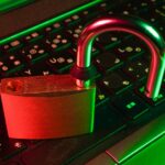 red padlock on black computer keyboard