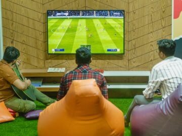 a group of people sitting in front of a flat screen tv