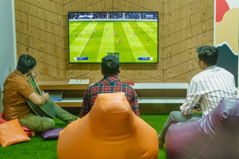 a group of people sitting in front of a flat screen tv