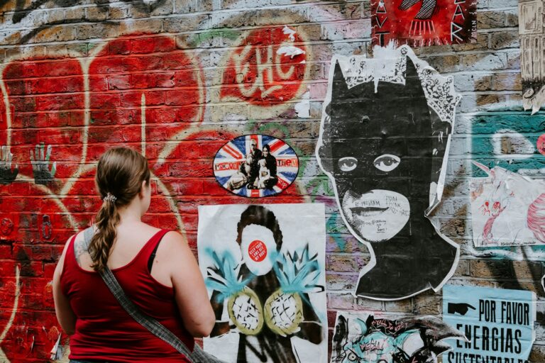 woman looking at batman graffiti wall art