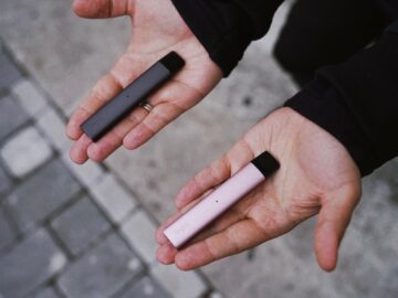 a person holding two electronic devices in their hands