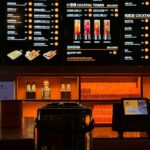 a menu board in a restaurant with drinks on it