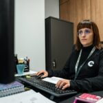 A woman is working at her office desk.