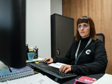 A woman is working at her office desk.