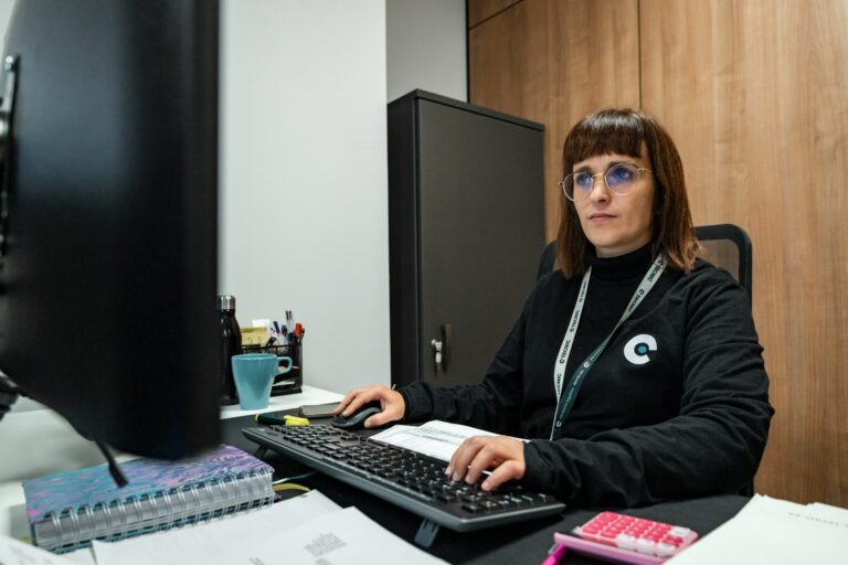 A woman is working at her office desk.