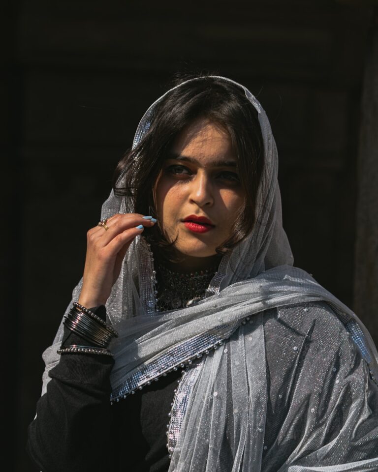 a woman in a veil smoking a cigarette