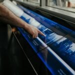 a man is pointing at a large poster