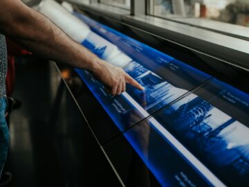 a man is pointing at a large poster