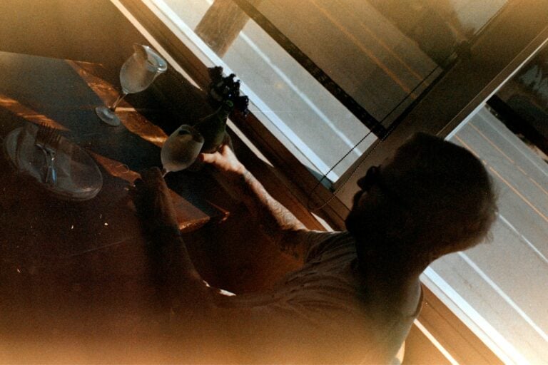 A woman standing in front of a mirror in a room
