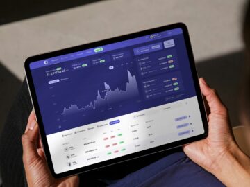 a person holding a tablet with a chart on it