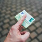 a person holding a piece of money in their hand