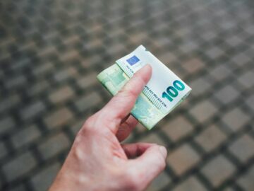 a person holding a piece of money in their hand