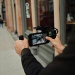 A man holding a camera up to take a picture