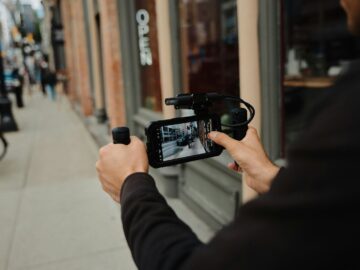 A man holding a camera up to take a picture
