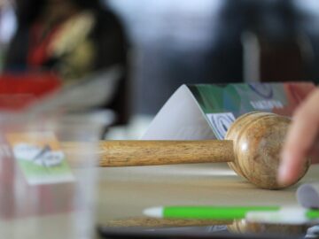a hand holding a wooden block