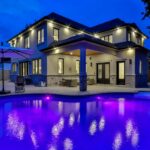 white concrete building near swimming pool during night time
