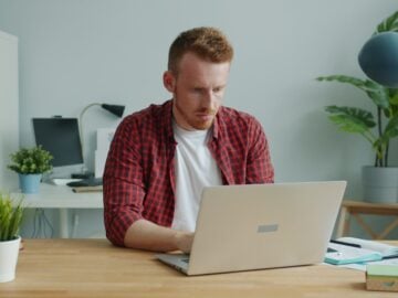 Man working on a laptop at a desk.
