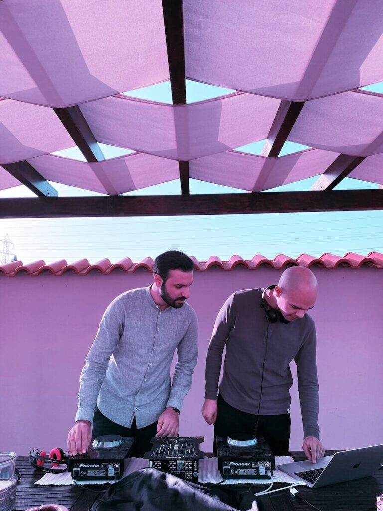 man in gray sweater and black pants standing beside man in gray sweater