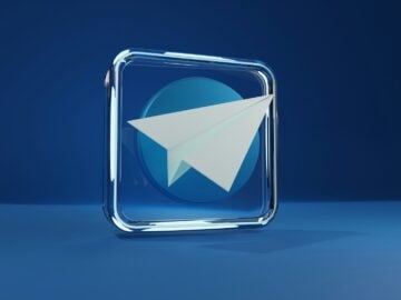 a blue square with a white paper airplane
