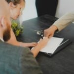 couple signing document at desk