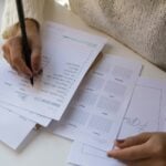 person writing on white paper