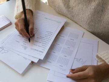 person writing on white paper