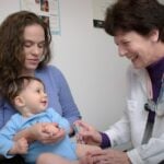 a young child is being examined by a doctor