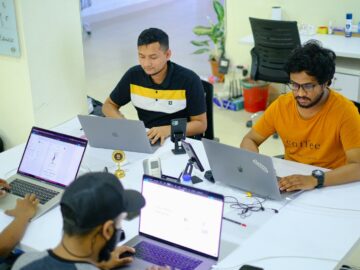 people sitting at the table using laptops
