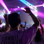 a group of people with their hands up in the air