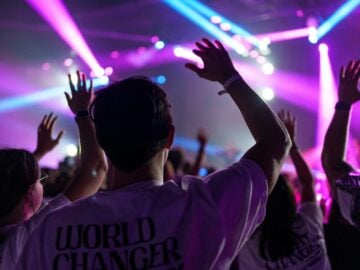a group of people with their hands up in the air