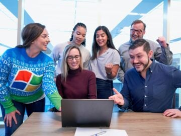 woman in maroon sweater using laptop